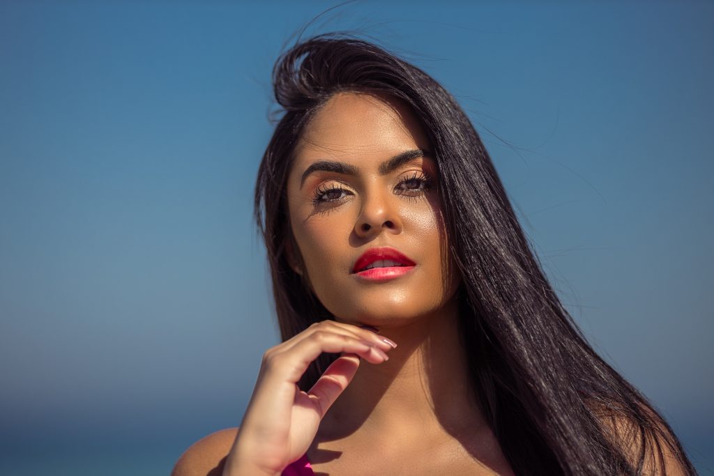 Woman with defined brows and pink manicure