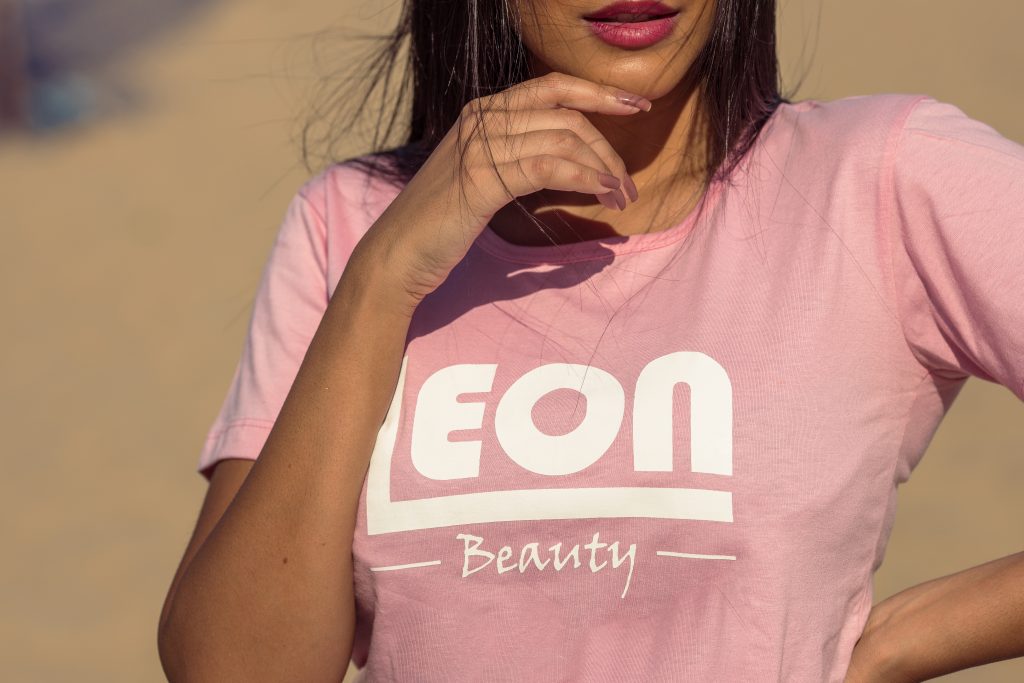 Woman wearing a pink Leon Beauty T-shirt