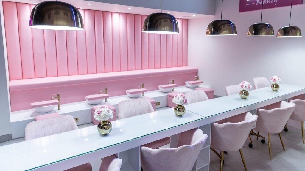 Pink nail bar with velvet chairs inside Leon Beauty