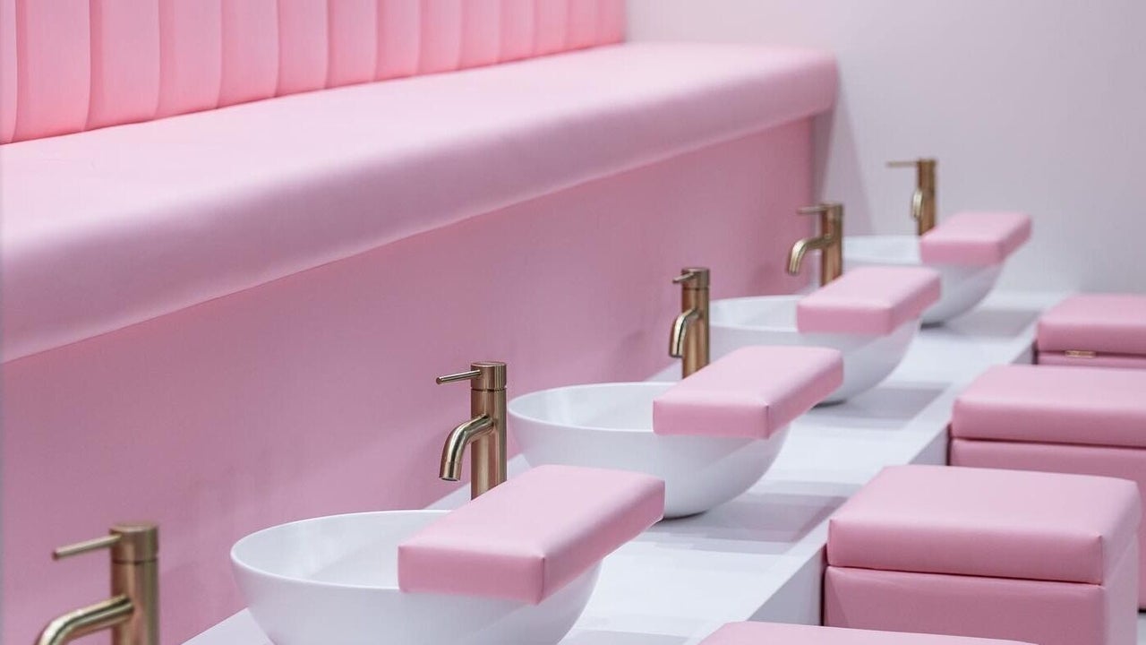 Pink pedicure stations with gold taps